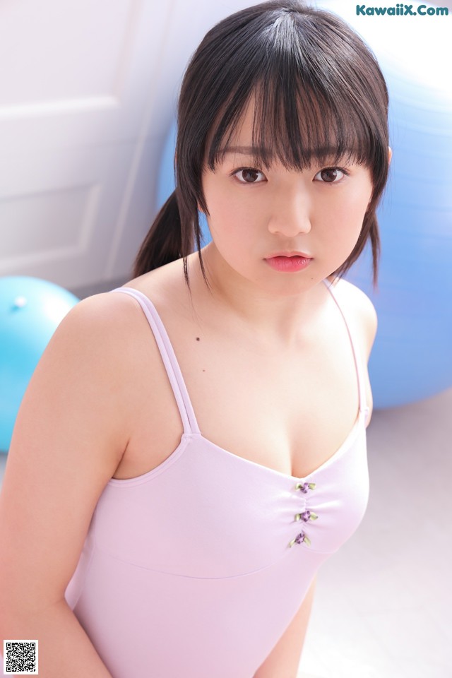 A woman in a pink bathing suit posing for a picture.