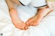 A close up of a person's feet on a bed.